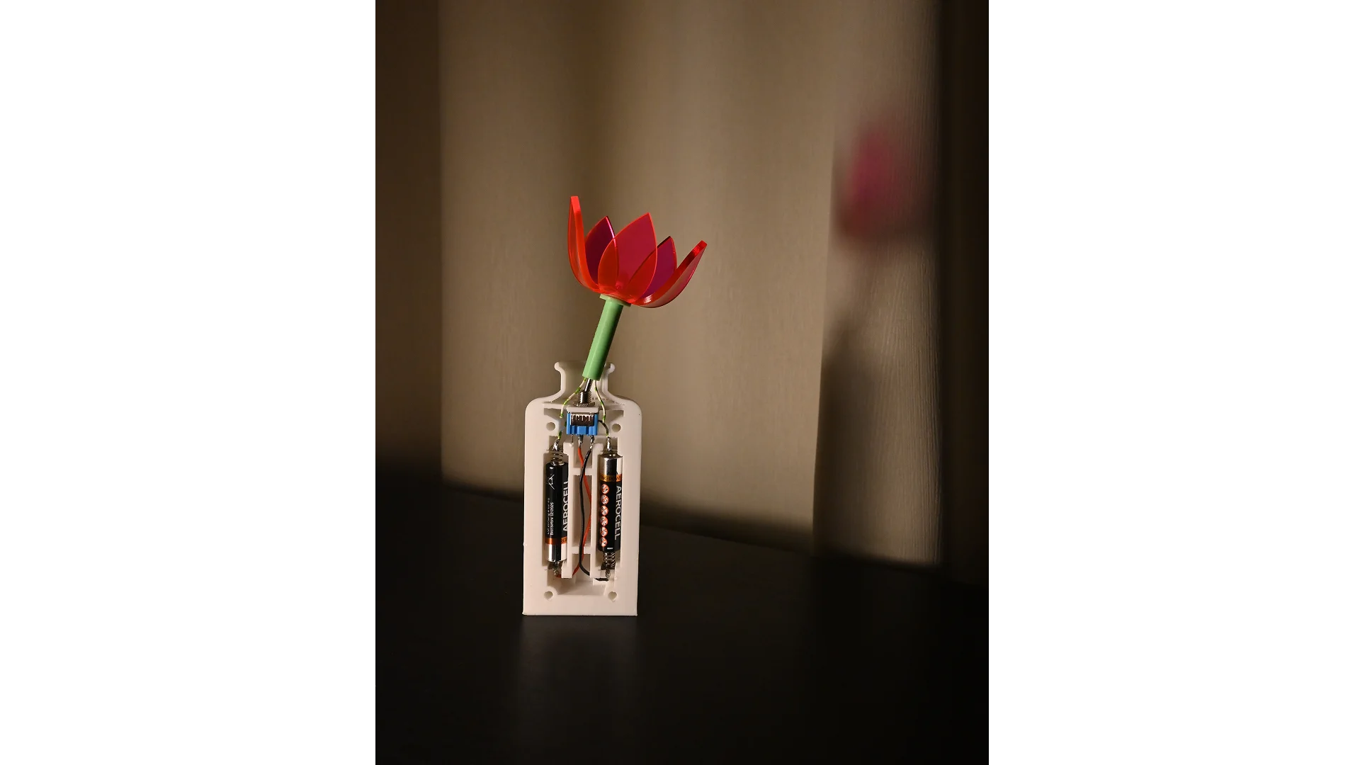 Vart liigutades sisselülitatav lamp. Modelleeritud Fusion 360-s, 3D-prinditud vaasiosa ja vars, laseriga lõigatud pleksiklaasist õis.